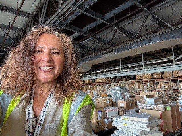 FedEx team member in warehouse facing camera