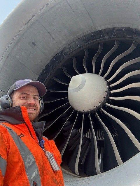 FedEx aircraft mechanic standing in an engine